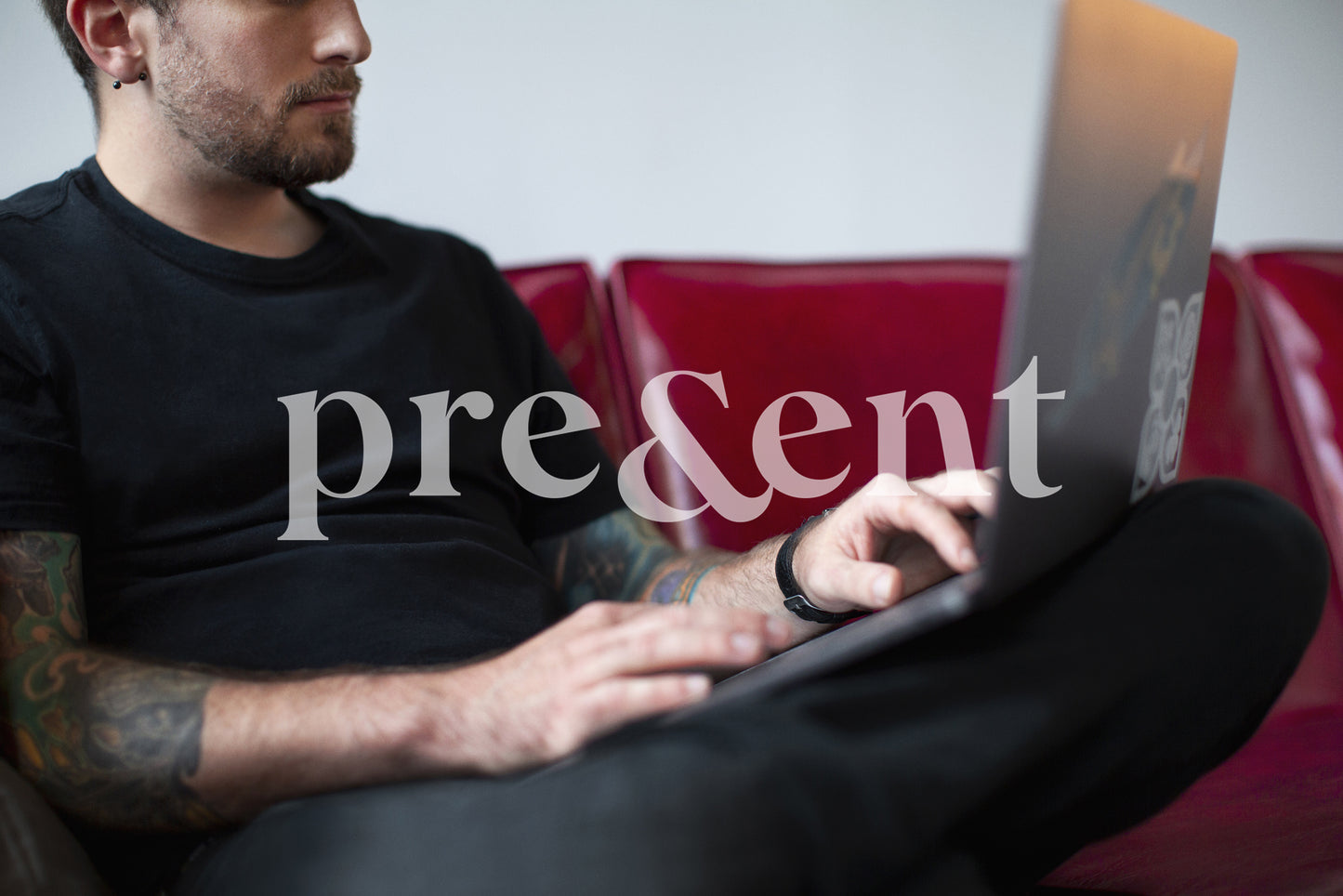Person working on a laptop computer while sitting on a couch