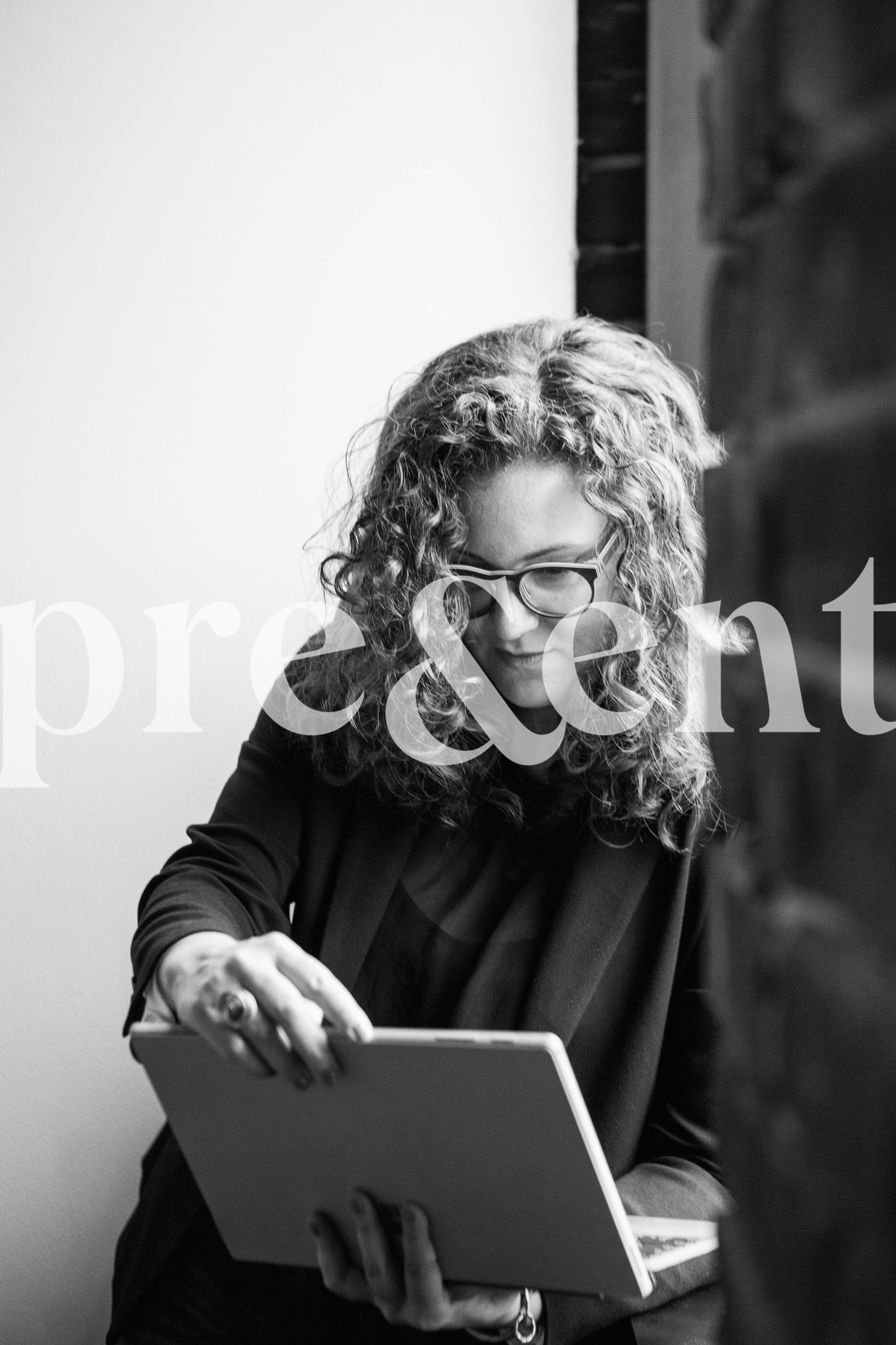 Professional working on tablet next to a window