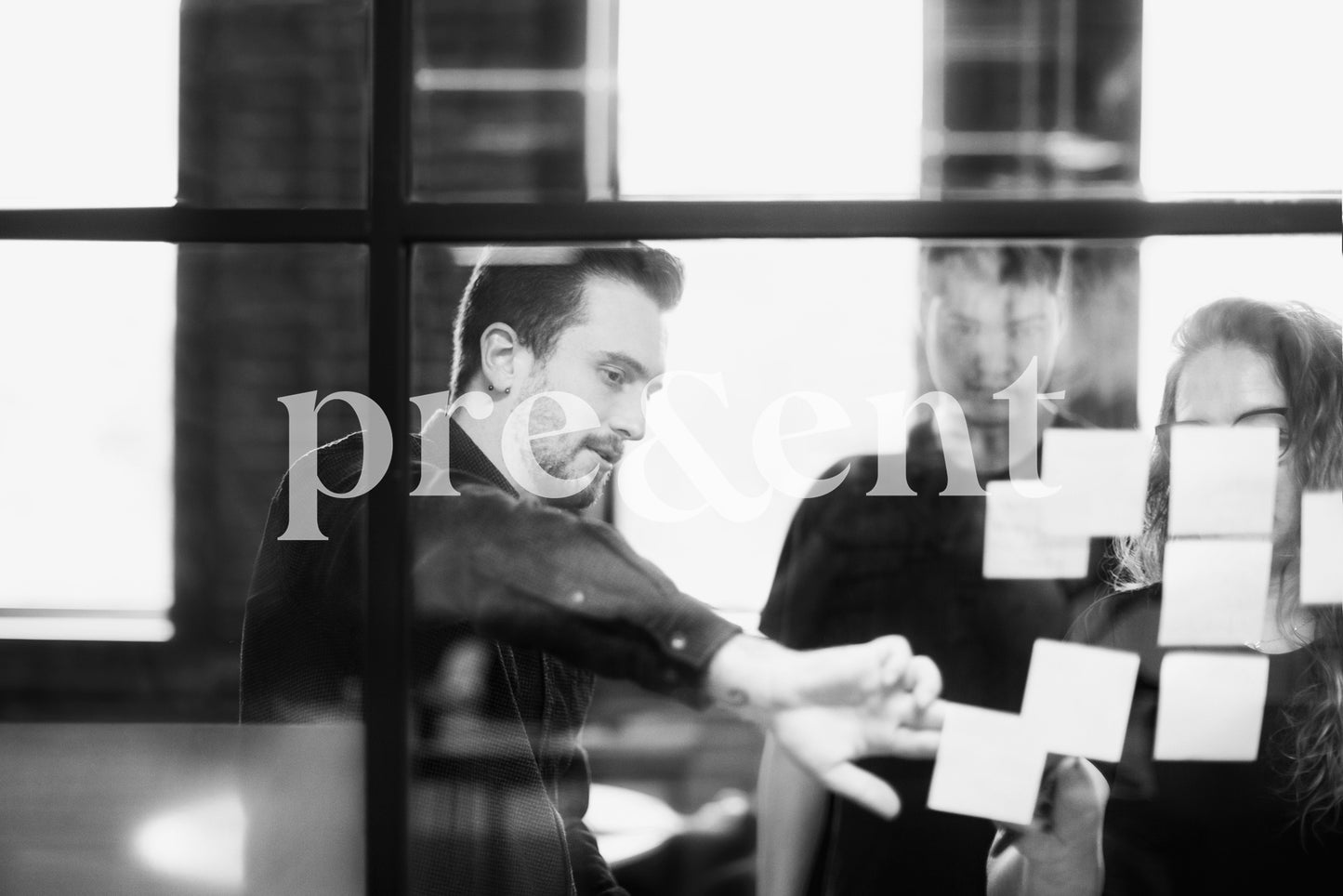 Colleagues brainstorming through window