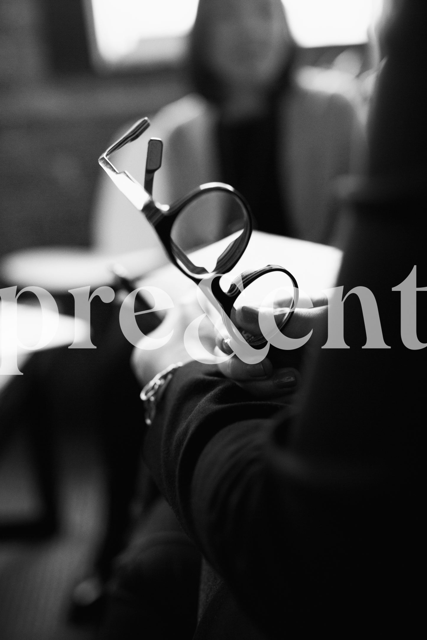 Person holding glasses while having a conversation