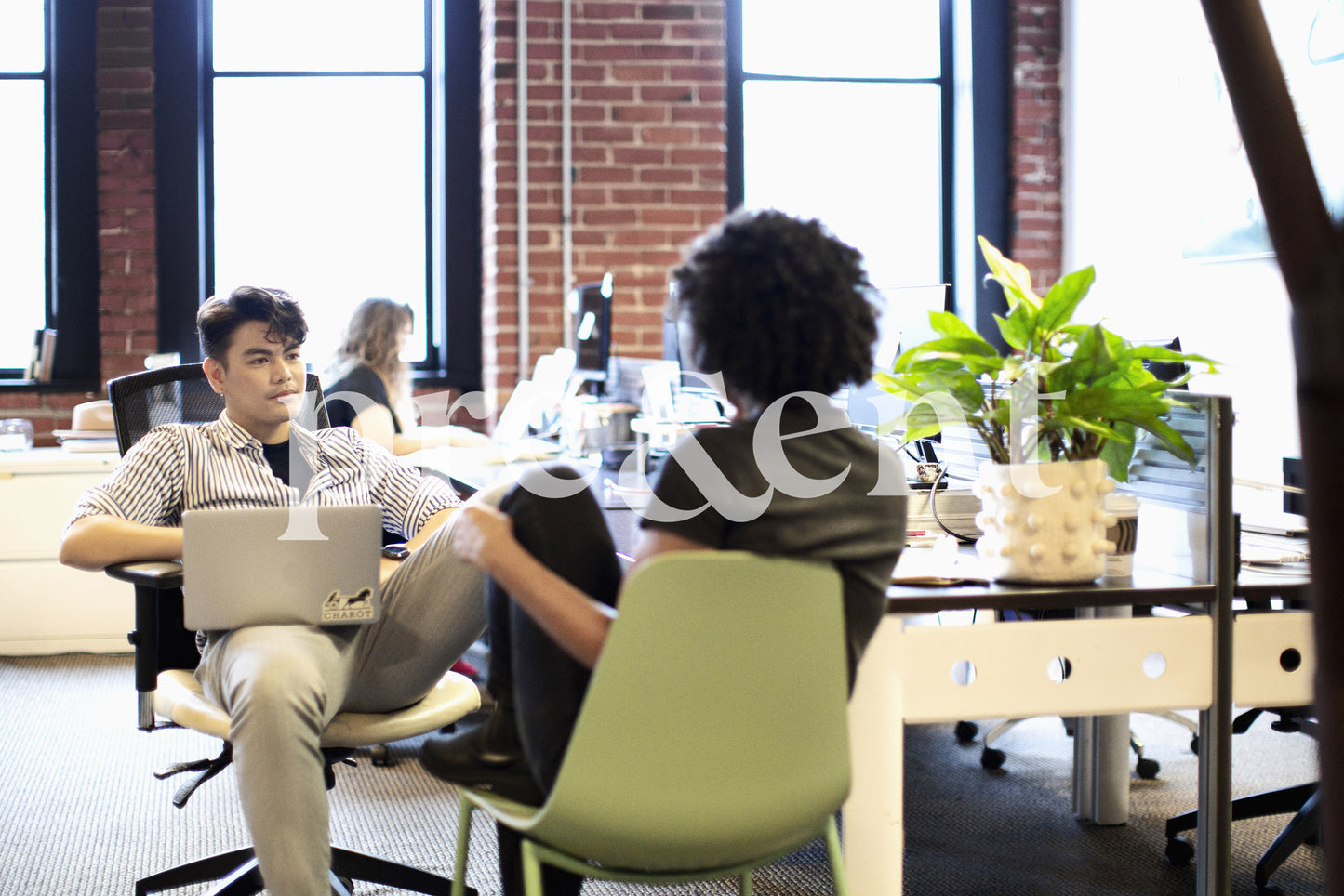 Casual conversation between colleagues in open space