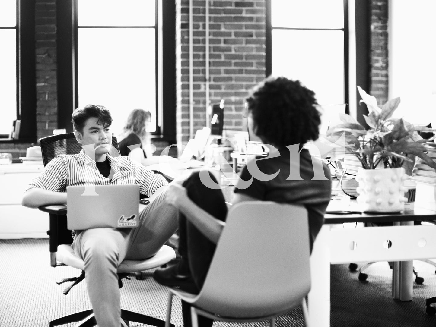 Casual conversation between colleagues in open space