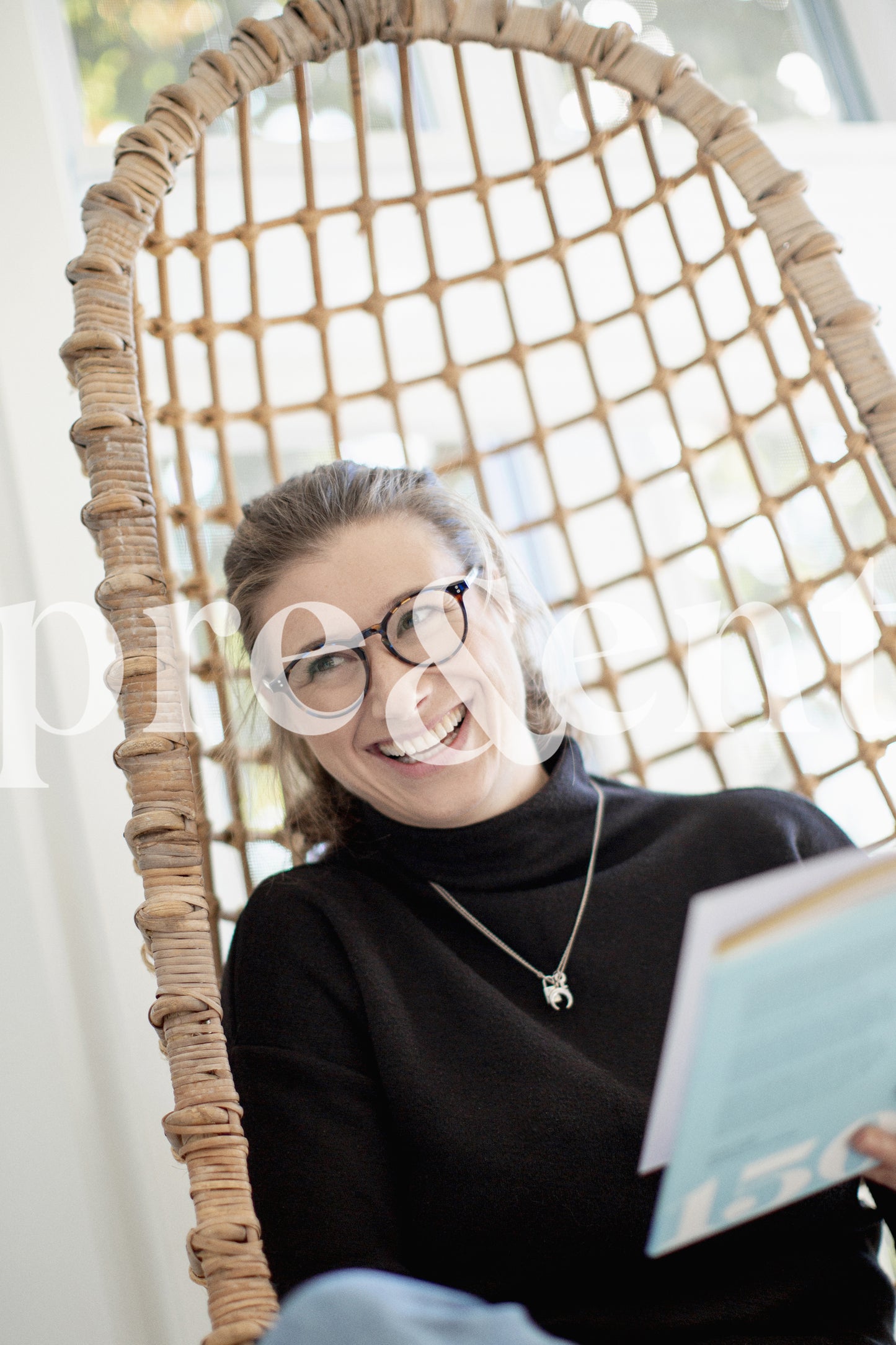 Person smiling while reading a book