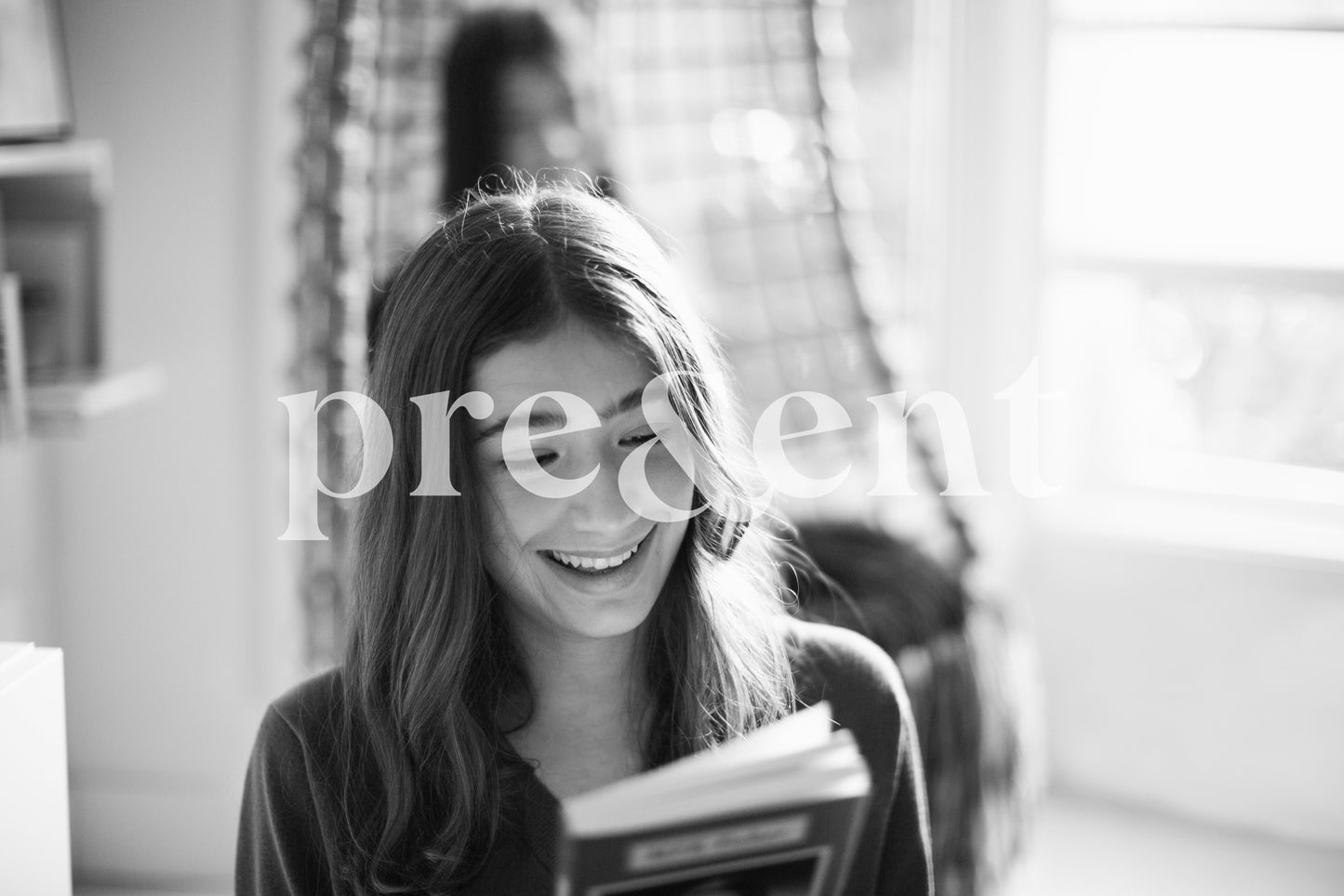 Looking at a book's cover in the living room