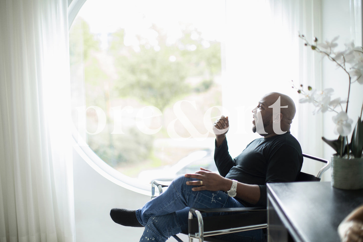 Sitting, looking through a window joyfully