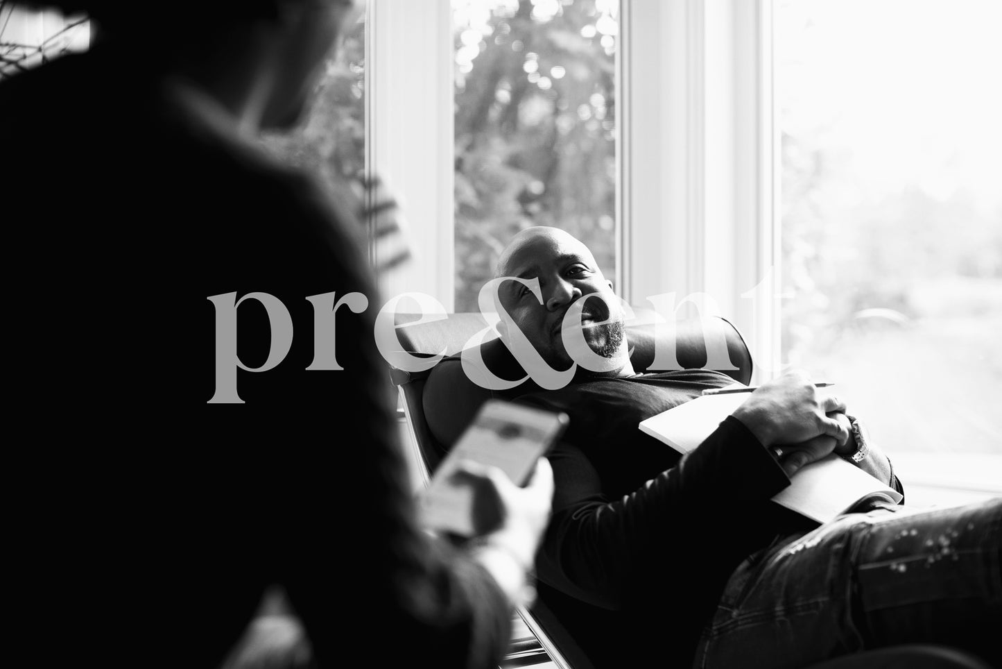 Person lying on a couch while looking at someone