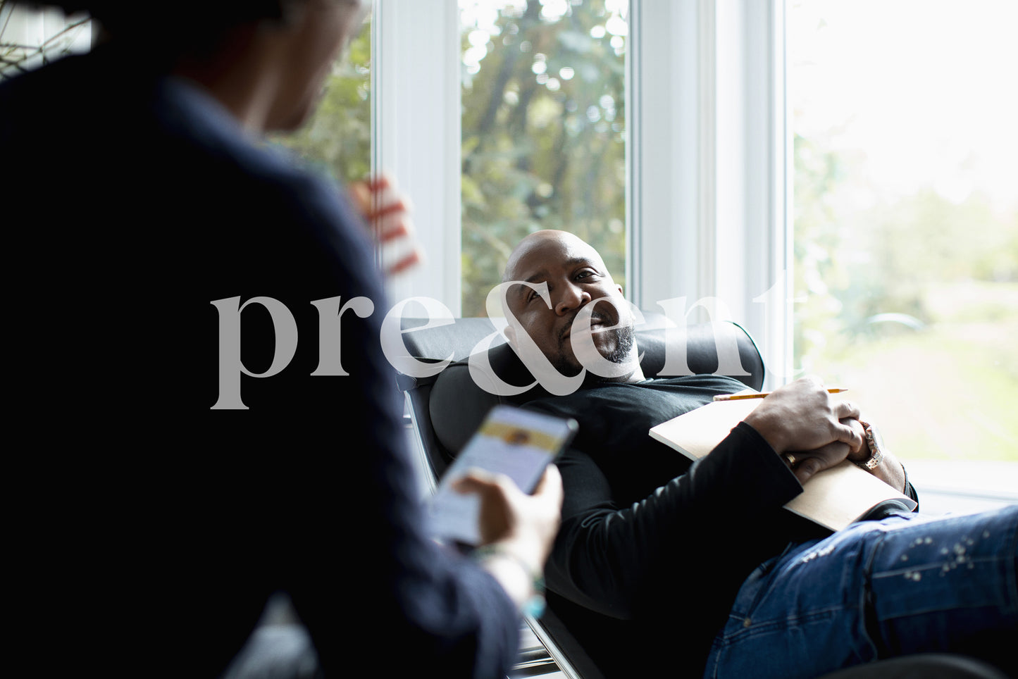 Person lying on a couch while looking at someone
