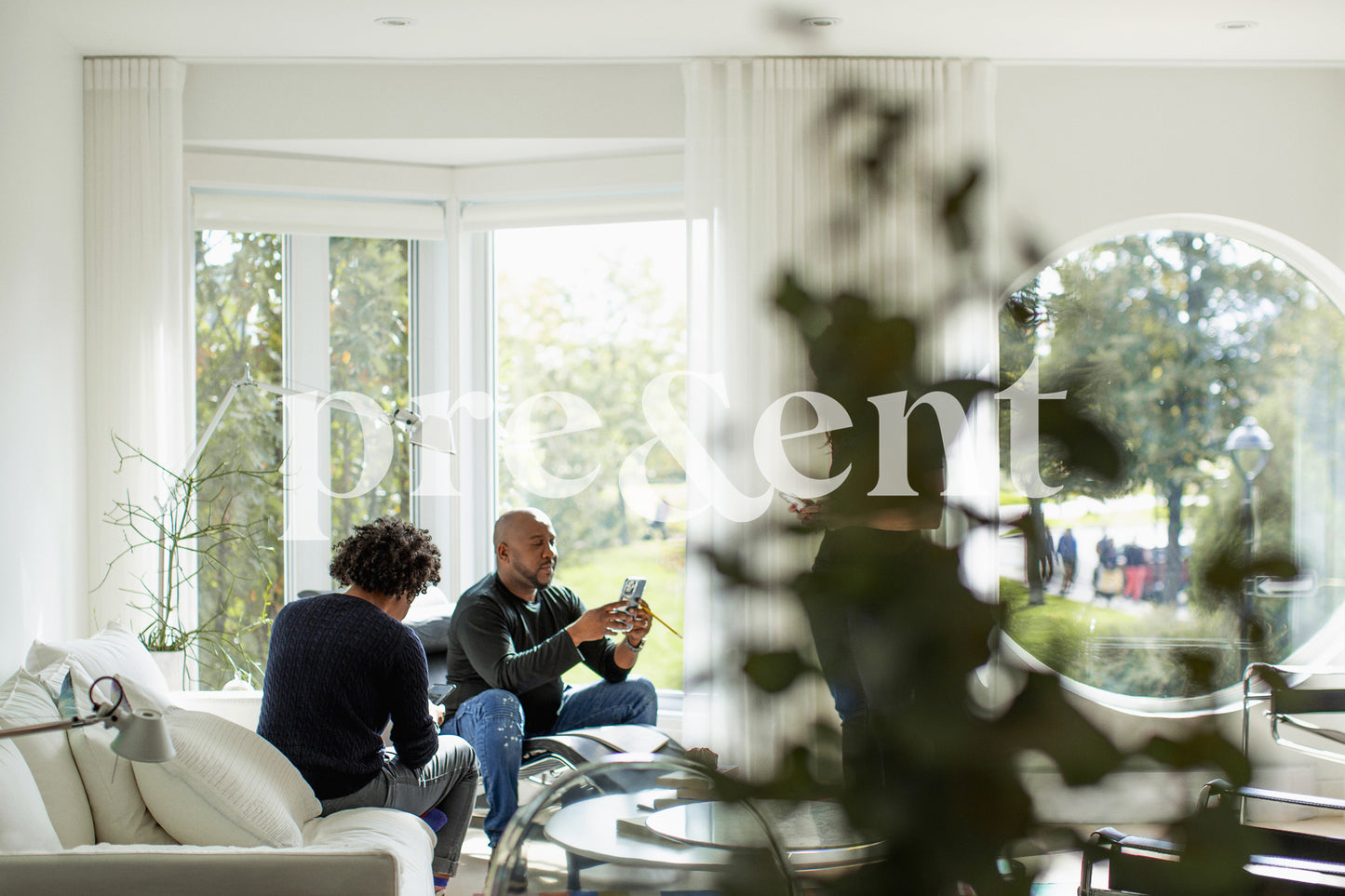 Couple of persons looking at their phone in living room