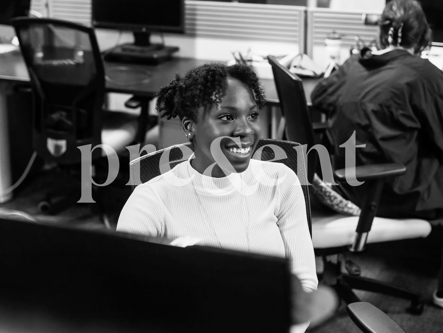 Smiling person at their desk