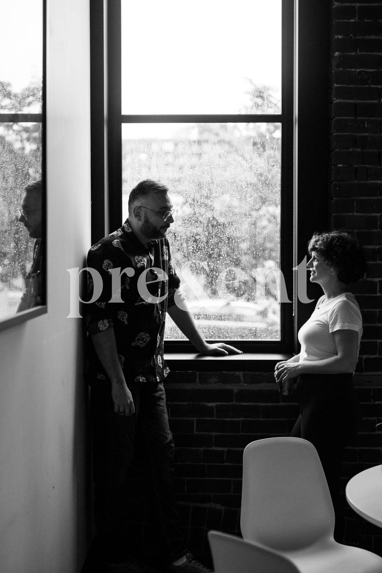 People discussing in front of a window
