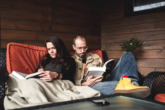 Couple at home reading on their balcony