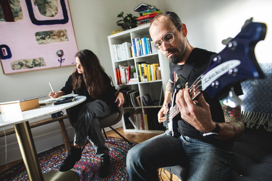 Person playing guitar at home