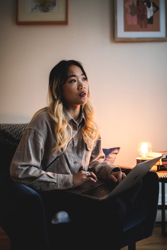 Thoughtful person working on a laptop from home