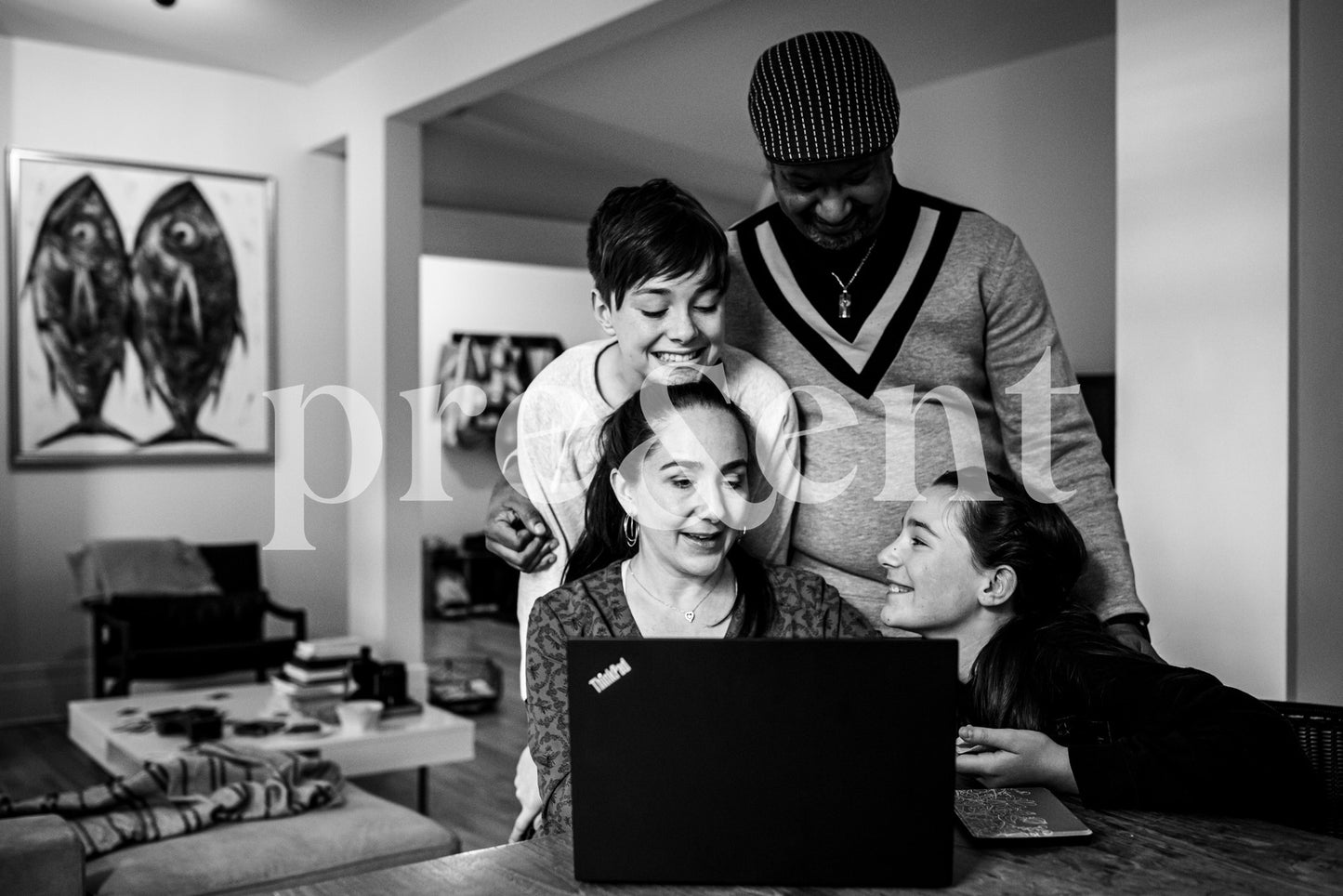Family gathered around a laptop