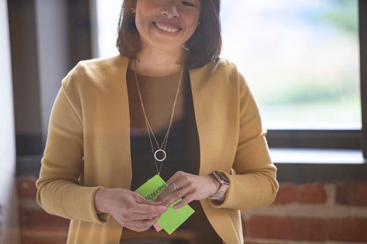 Smiling person holding Post-it notes