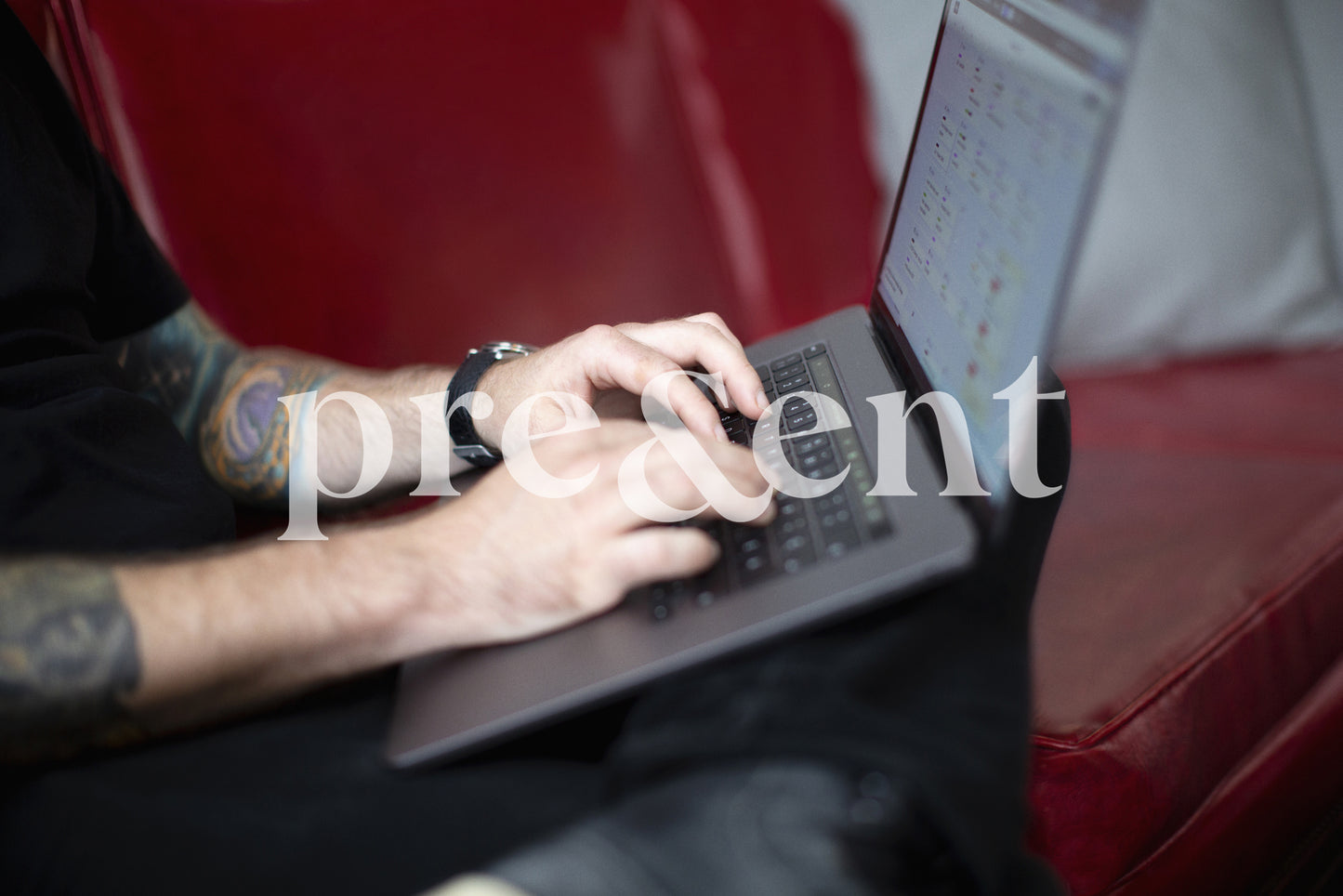 Person typing on a laptop while sitting