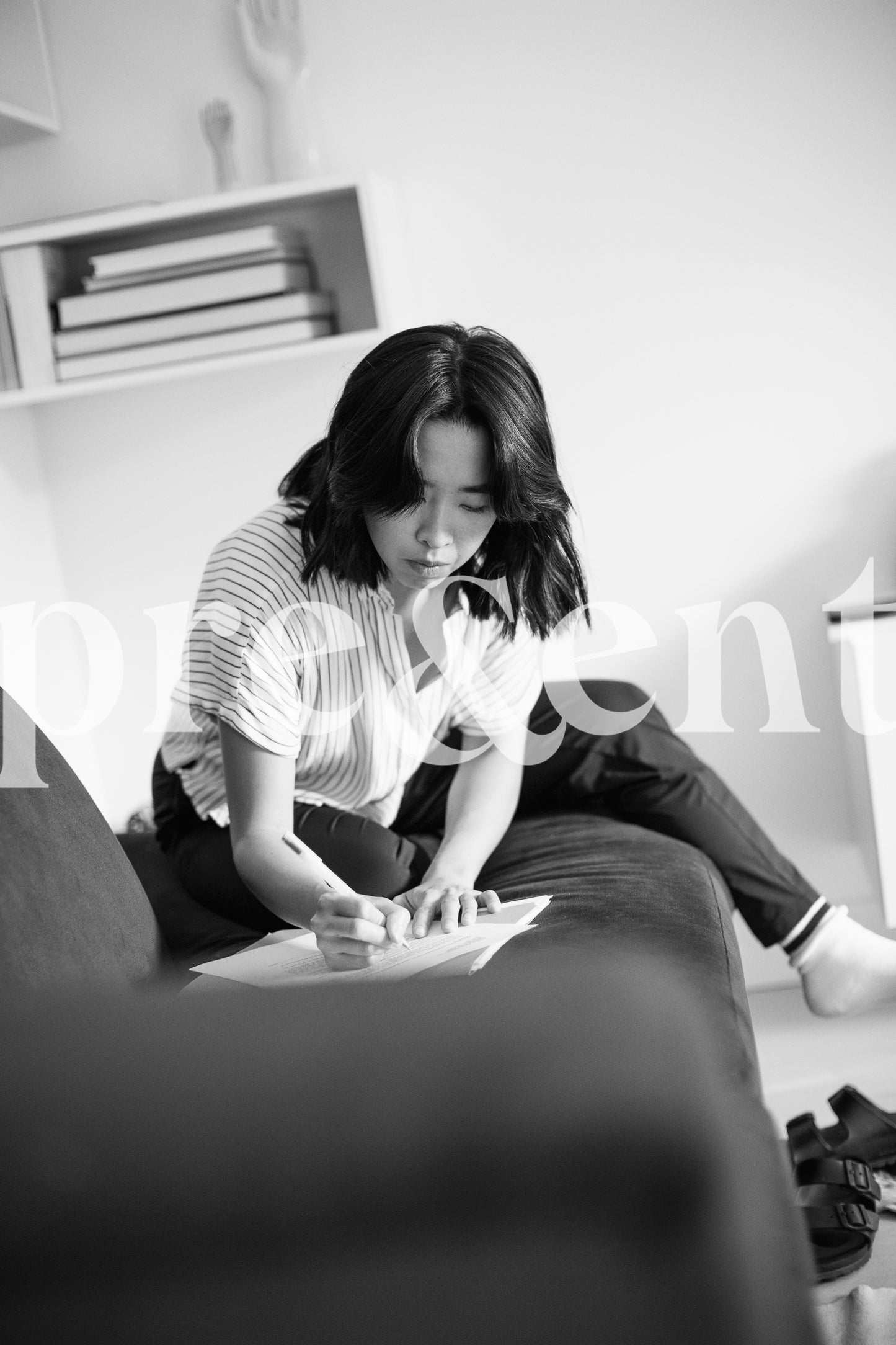 Focused person taking notes in living room