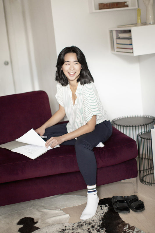 Joyful person sorting papers on a couch