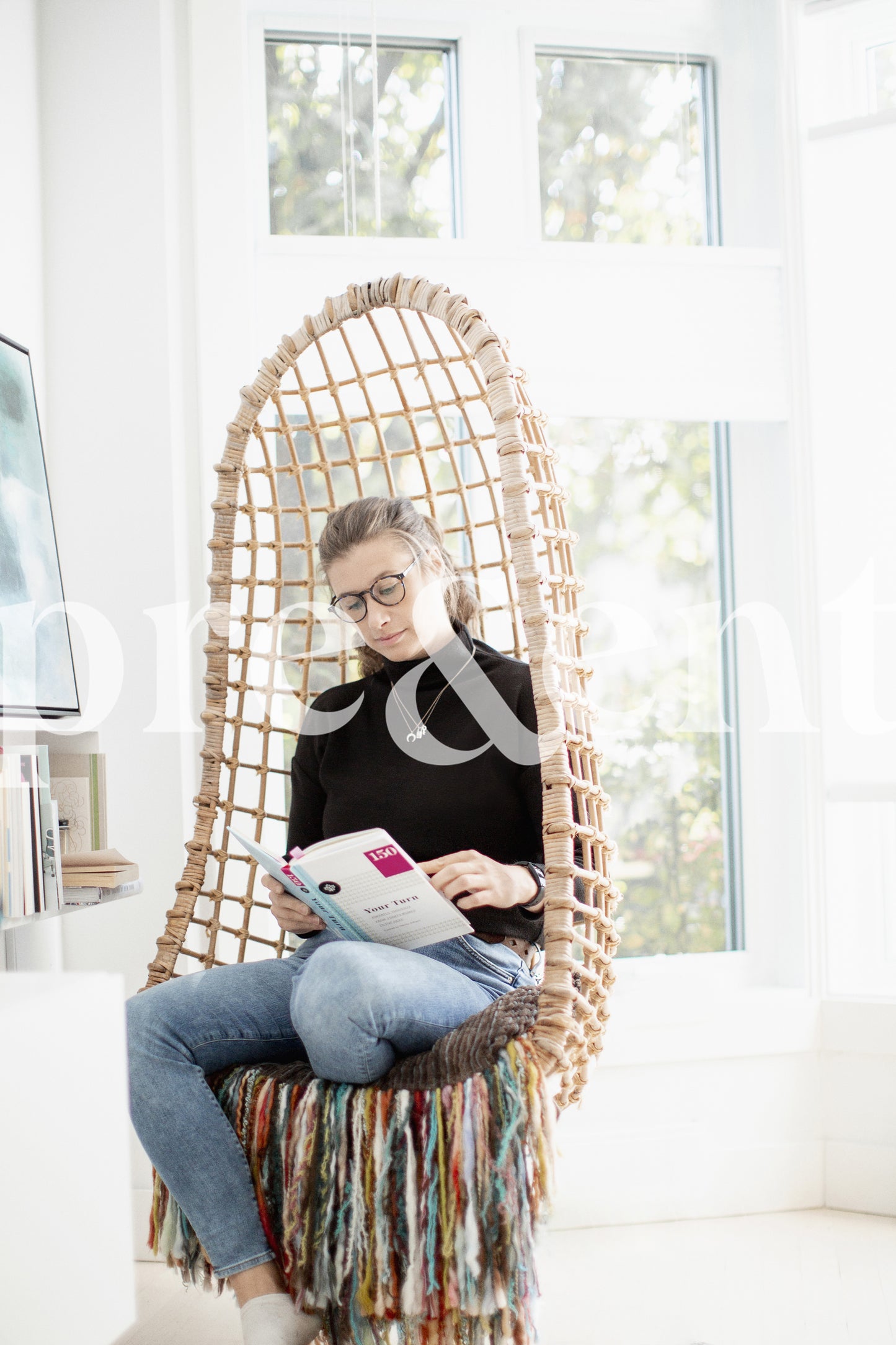 Person reading a book in a cozy chair