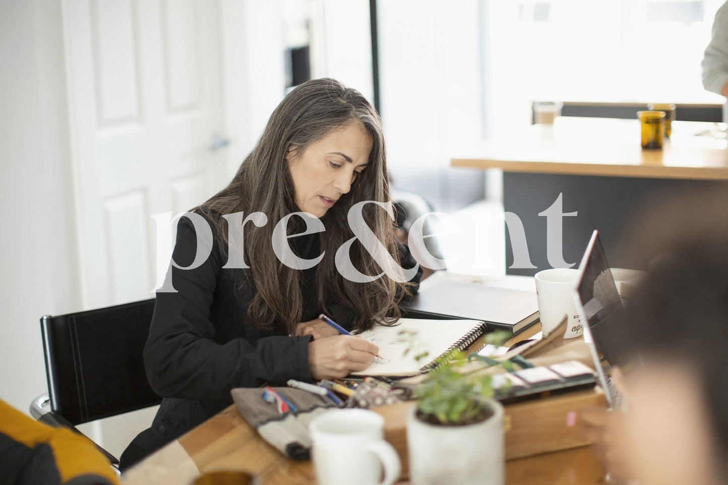Person drawing at a table