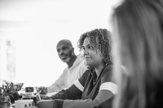 Group sitting at table, looking attentive