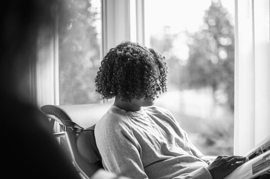 Reading a magazine by the window