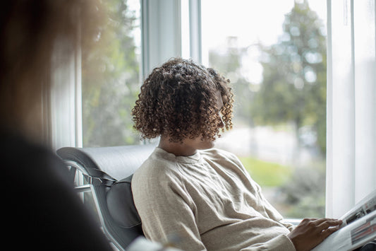 Reading a magazine by the window
