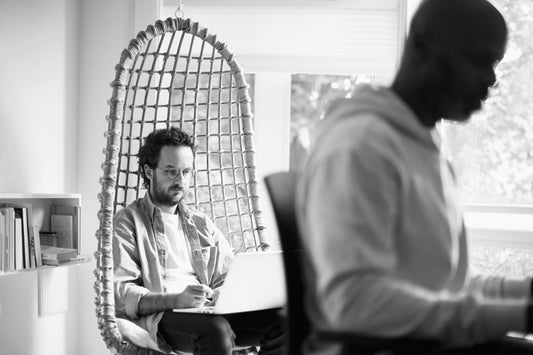 Someone focusing on work in a hanging chair