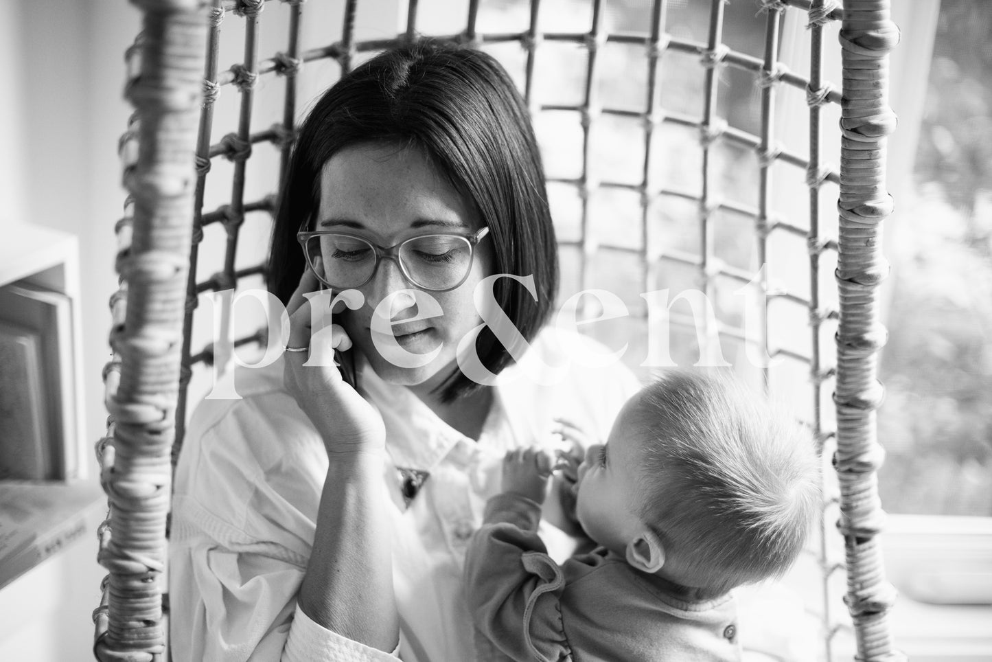 Someone holding a child while talking on the phone