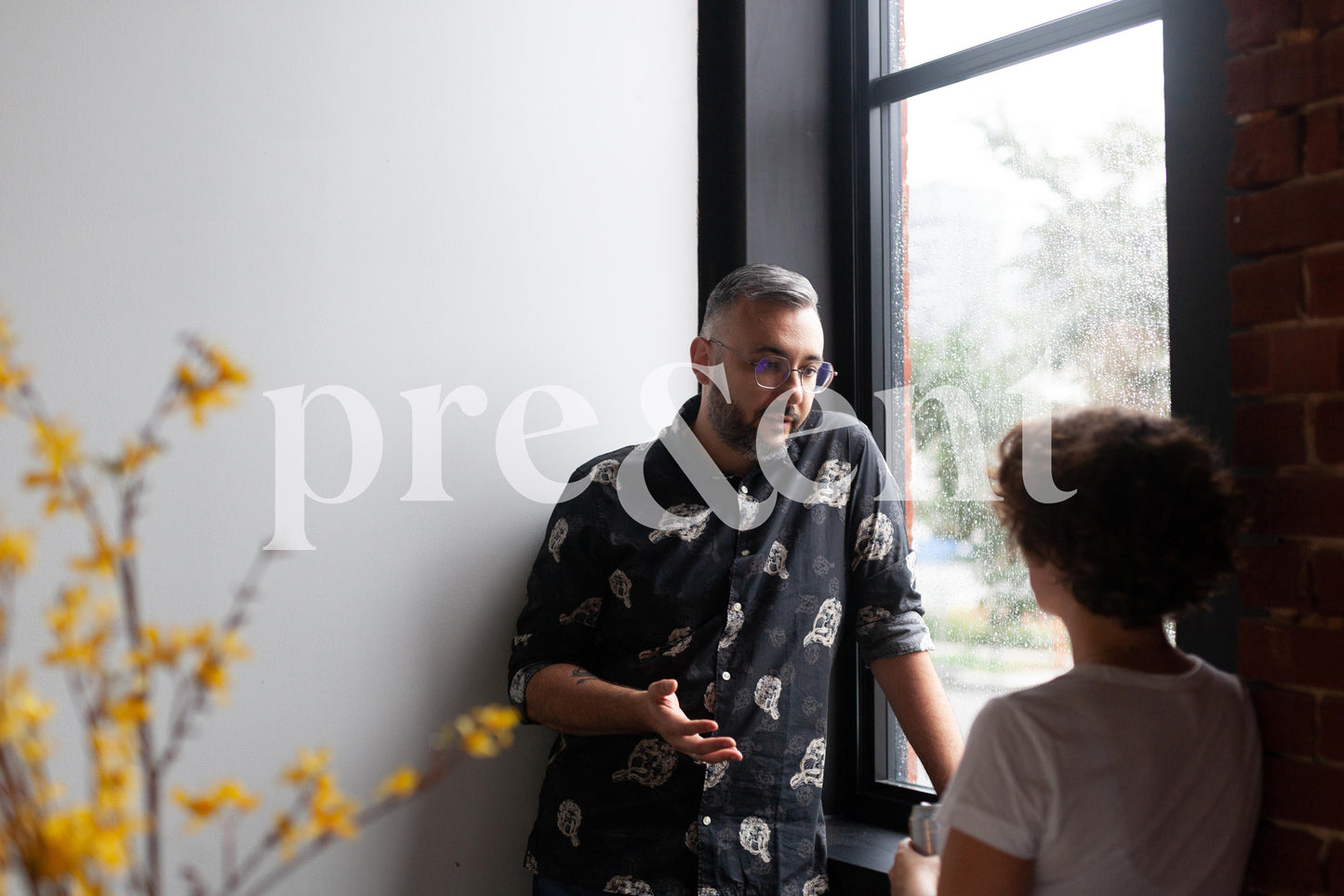 People discussing in front of a window