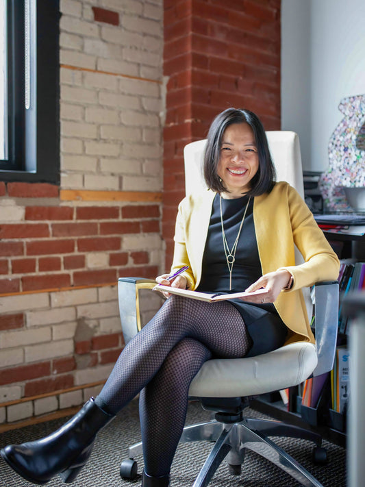 Personne souriante, assise dans son bureau