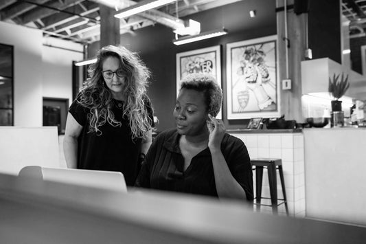 Colleagues exchanging ideas in an open space office