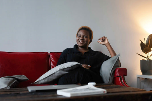 Smiling person sitting on a couch