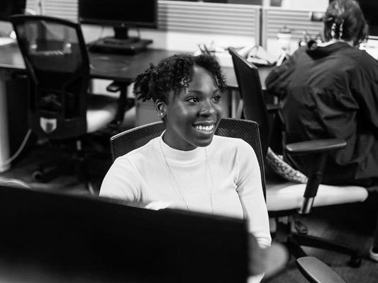 Smiling person at their desk