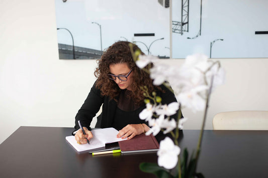 Person taking notes at a conference table